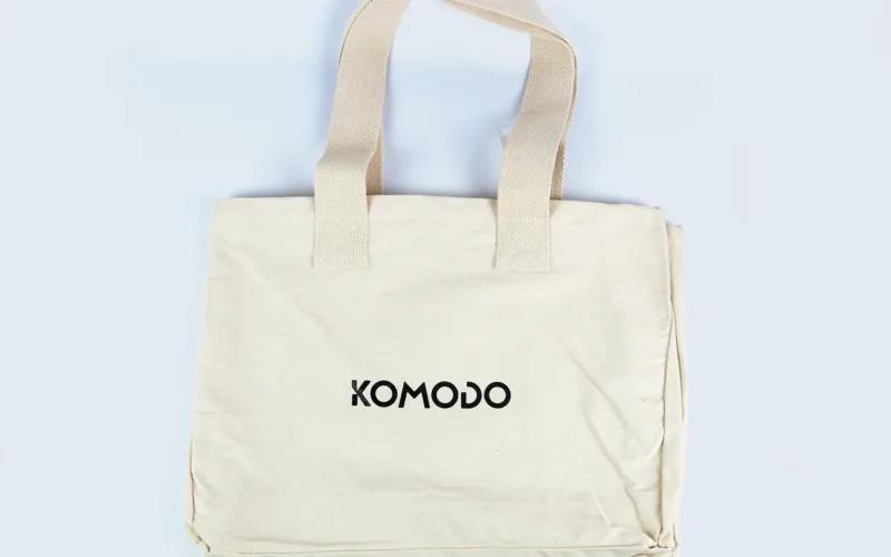 A plain beige tote bag with the word 