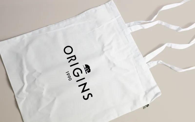 A white tote bag with the word 