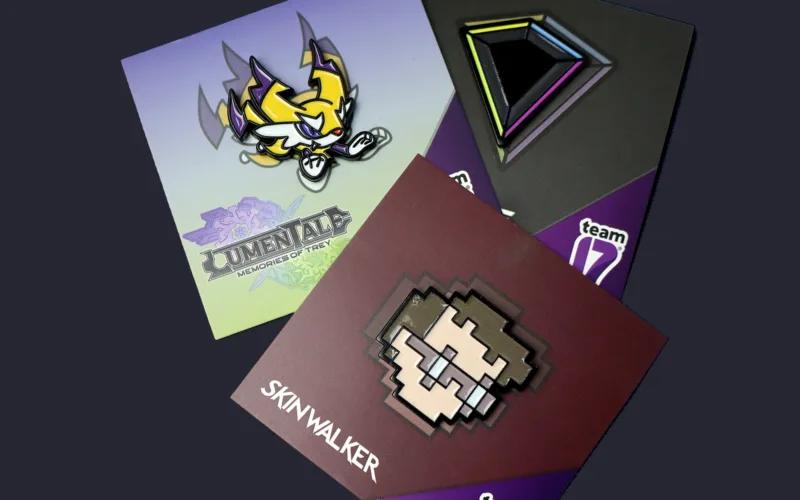 Three collectible pins featuring designs from different games, including 