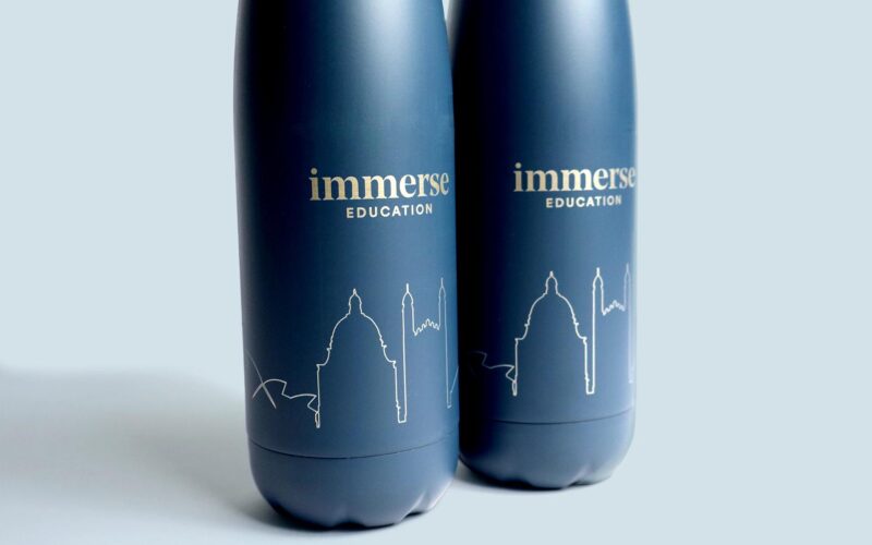 Two dark blue water bottles with the text 