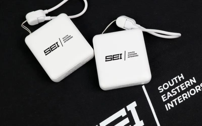 Two white charging blocks with the logo 