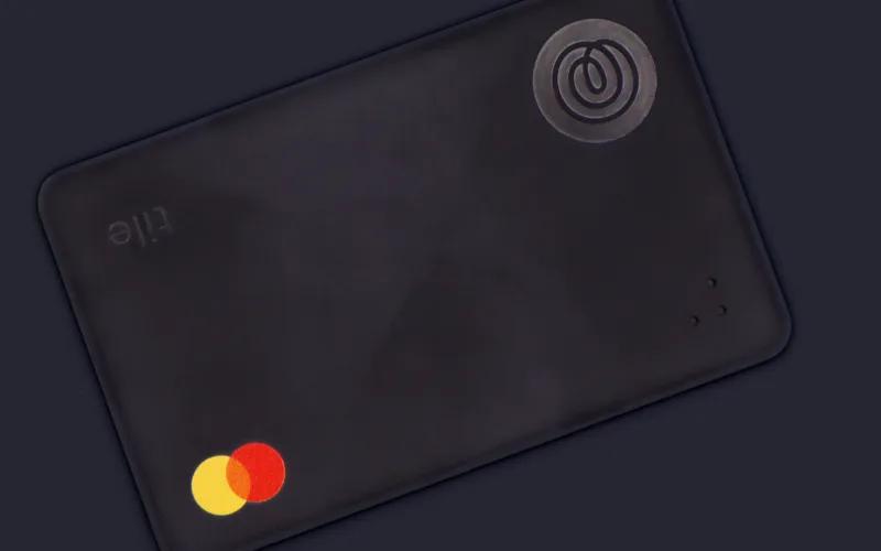 A black card featuring the Mastercard logo and a circular emblem.