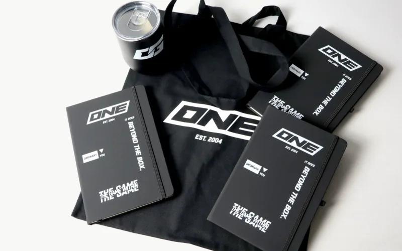 A black tote bag with the logo 