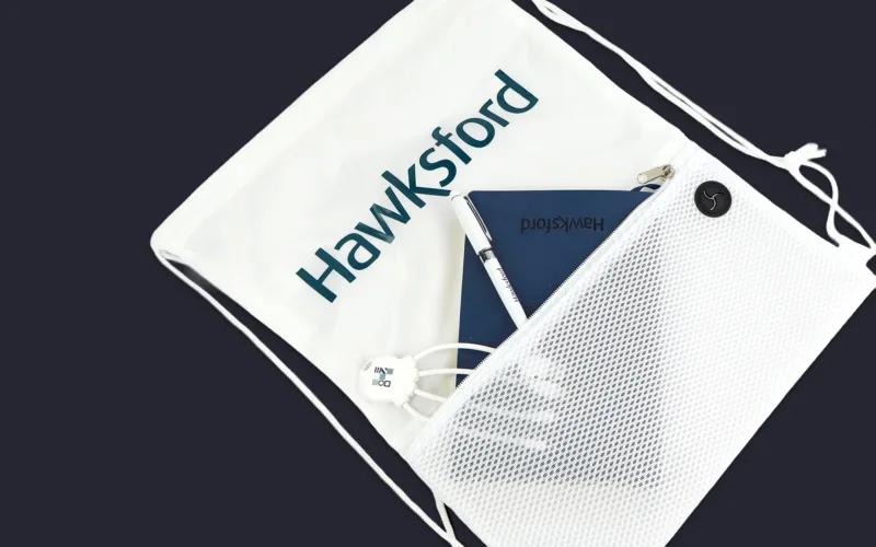 A white drawstring bag with the logo 