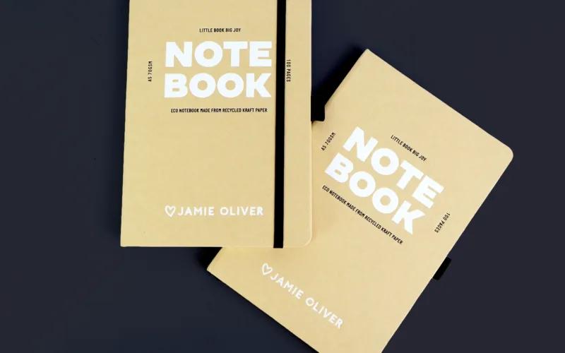 Two eco-friendly notebooks made from recycled kraft paper, labeled 