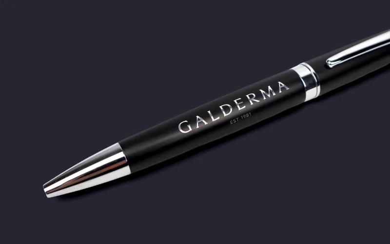 A black pen with a silver tip, featuring the word 