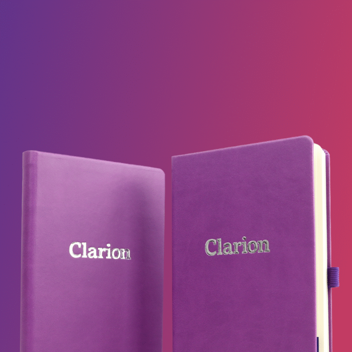 Two purple notebooks with the word 