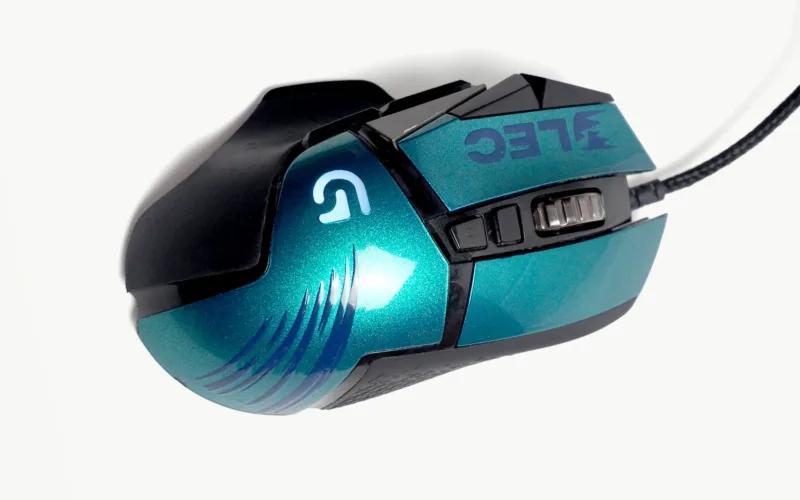 A turquoise and black gaming mouse with various buttons and a textured grip.