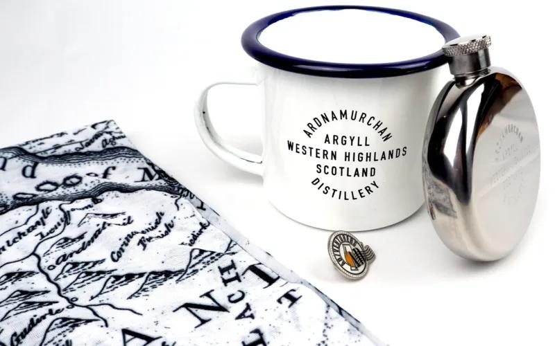 A white enamel mug with a blue rim labeled 