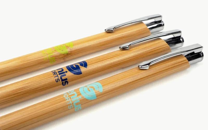Three bamboo pens with metal clips, featuring different colored logos.