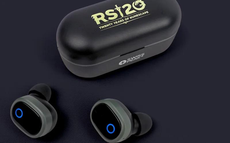 A pair of wireless earbuds next to their charging case, featuring the text 